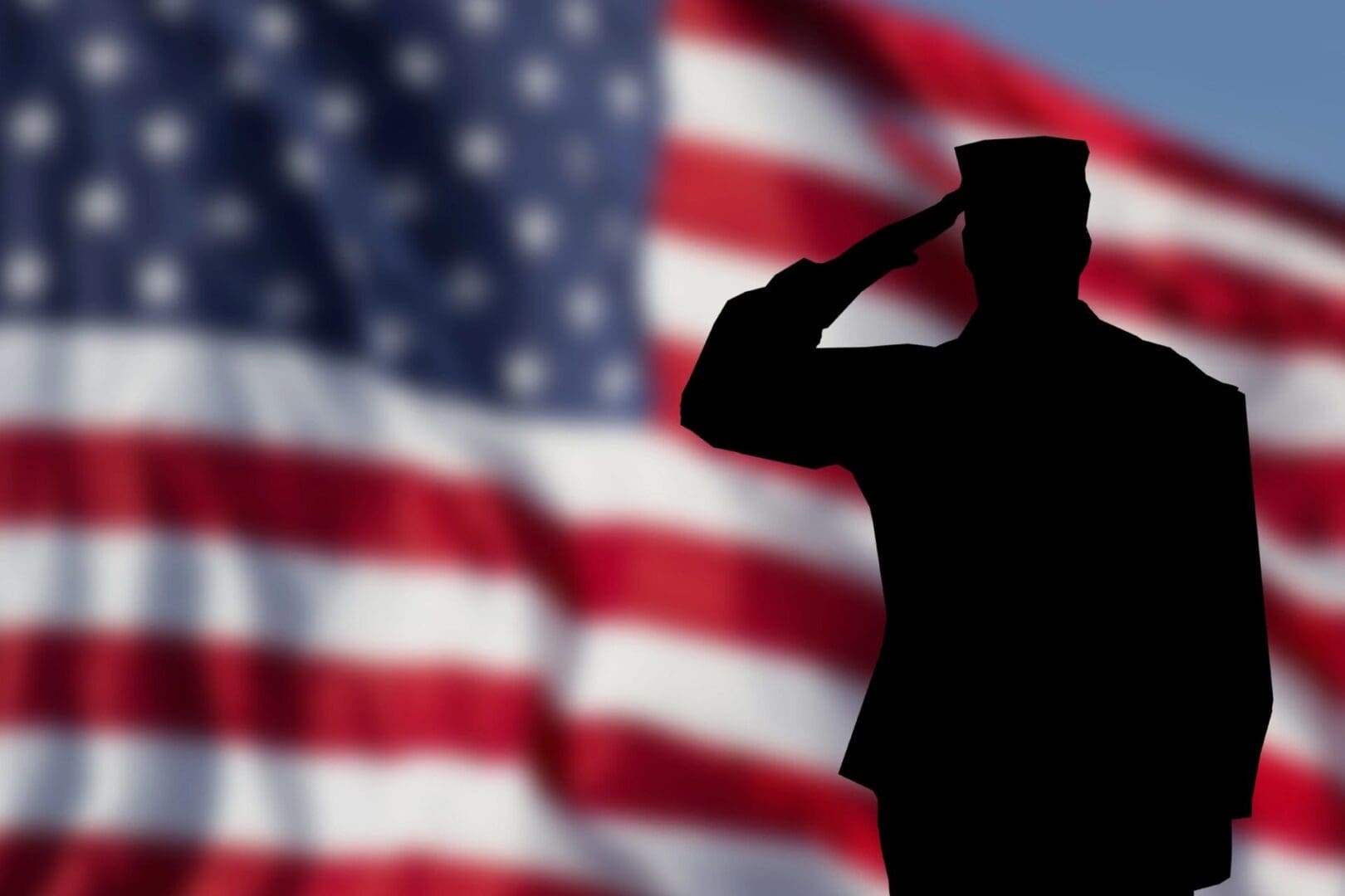 A soldier saluting in front of an american flag.