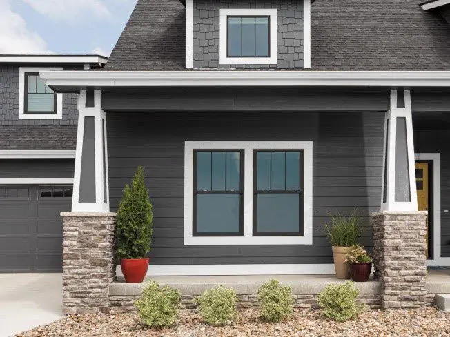 A house with two windows and a porch.